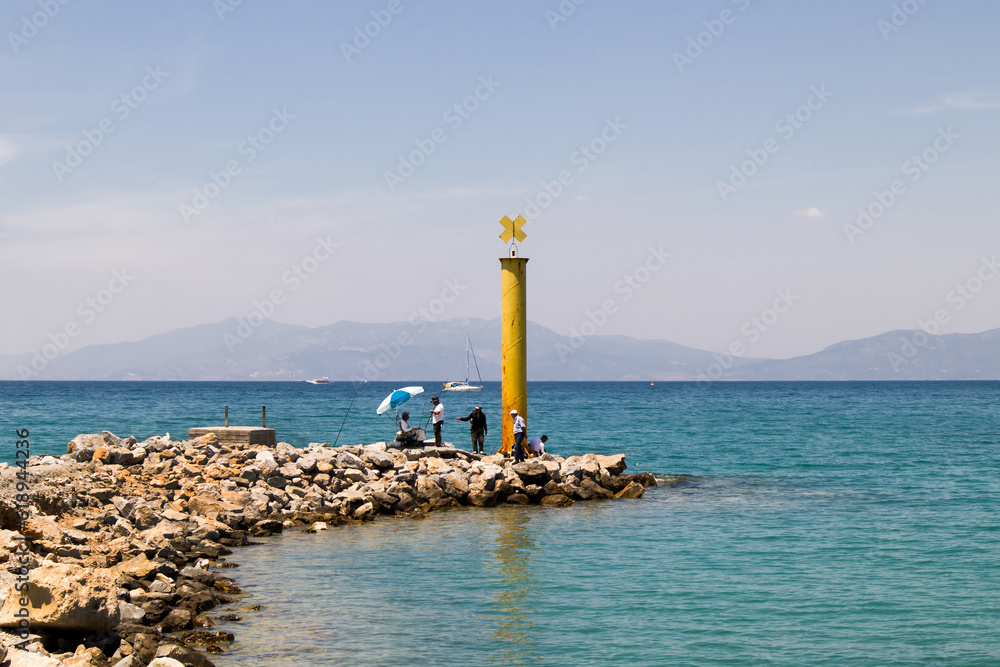The yellow colored breakwater is above the sea designed with decorative stones. The yellow colored breakwater is above the sea designed with decorative stones.