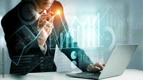 Fotografie Businessman analyst working with digital finance business data graph showing technology of investment strategy for perceptive financial business decision