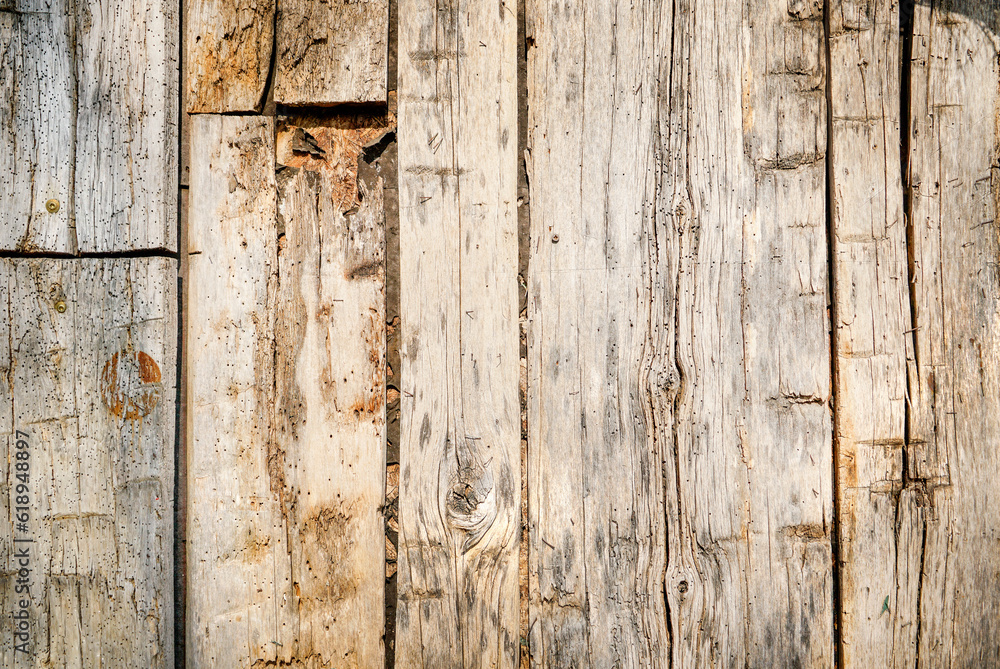 Dark stained reclaimed wood surface with aged boards lined up. Wooden