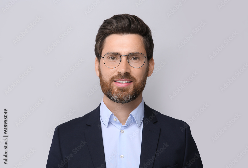 Portrait of handsome man in glasses on light grey background Portrait of handsome man in glasses on light grey background