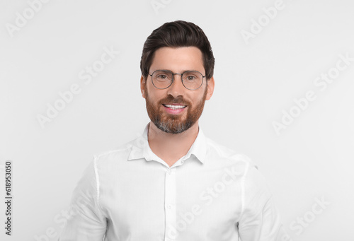 Portrait of handsome man in glasses on white background