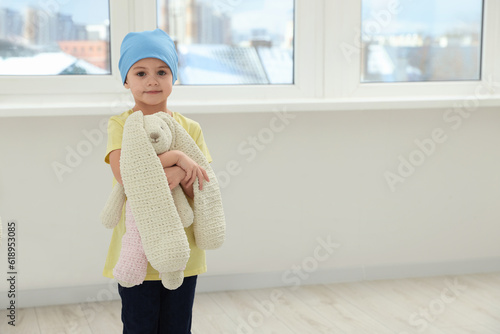 Fototapeta Childhood cancer. Girl with toy bunny in hospital