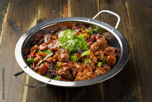 Special Sichuan cuisine griddle chicken on dark background
