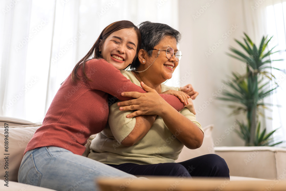 Portrait of enjoy happy love asian family senior mature mother and young daughter smiling play laughing and having fun together at home, care, elderly, insurance.happy family and Mother Day concept Portrait of enjoy happy love asian family senior mature mother and young daughter smiling play laughing and having fun together at home, care, elderly, insurance.happy family and Mother Day concept