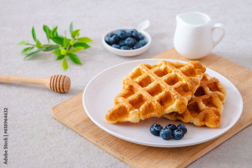 Croffle or croissant waffle with blueberries on plate Croffle or croissant waffle with blueberries on plate