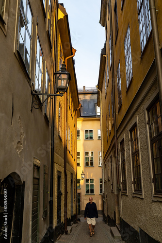 Stockholm, Sweden A man walks on a narrow cobblestones street in Gamla Stan or Old Town on Ankargrand.