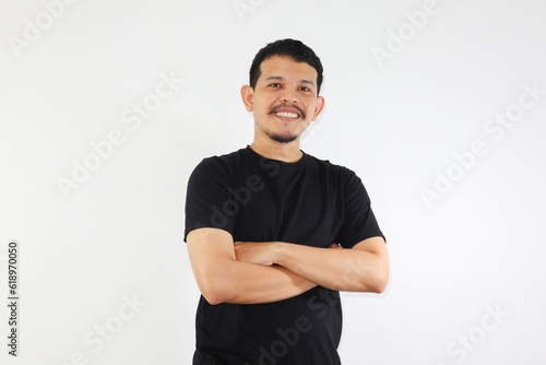 Adult Asian man standing confident with arms crossed showing happy expression