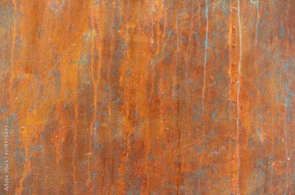 orange rust stains on weathered steel plate or yellow iron table and old brown metal wall by moisture with rivet nut head for dirty board background or red retro backdrop ancient texture on top view orange rust stains on weathered steel plate or yellow iron table and old brown metal wall by moisture with rivet nut head for dirty board background or red retro backdrop ancient texture on top view