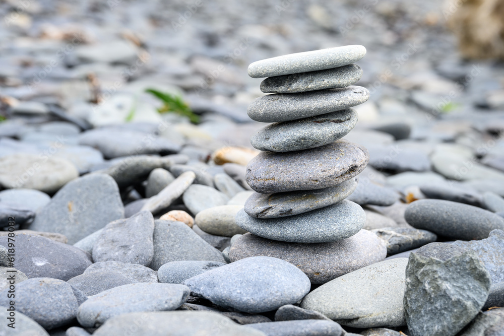 Calming stack of flat round stones on a rocky beach, ready for meditation, zen background
Calming stack of flat round stones on a rocky beach, ready for meditation, zen background