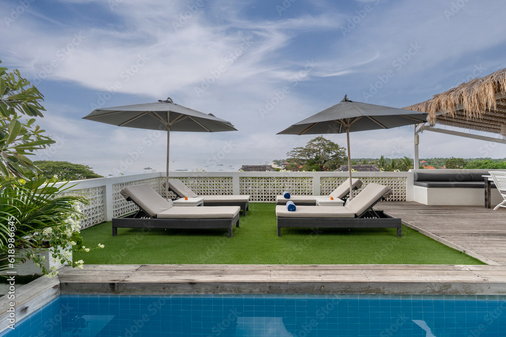 Fototapeta premium Beach sun lounges at hotel pool