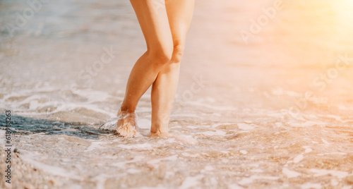 A woman walks along the beach, legs close-up. Barefoot woman sta