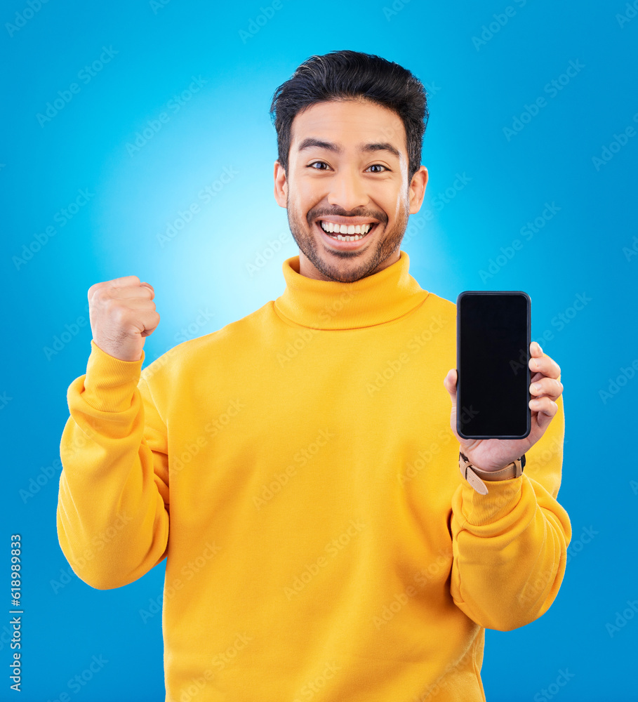 Success, portrait and man with phone screen against a blue background for achievement. Technology or app, winning or celebrating and male person with smartphone cheering for sales deal announcement Success, portrait and man with phone screen against a blue background for achievement. Technology or app, winning or celebrating and male person with smartphone cheering for sales deal announcement