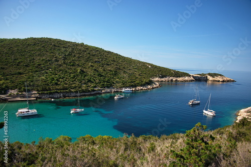 Deep bay in Adriatic sea with sailboats anchored in clear blue water