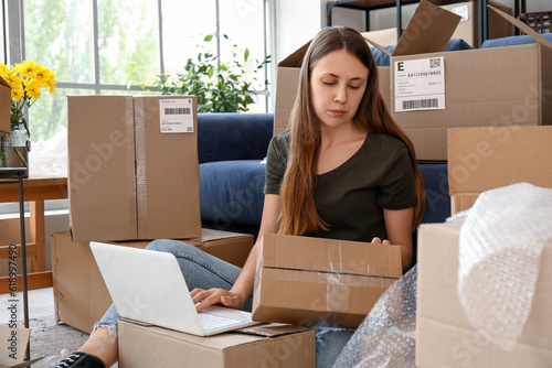 Young woman with parcel usi...