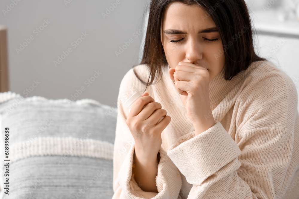 Sick coughing woman with pills at home Sick coughing woman with pills at home