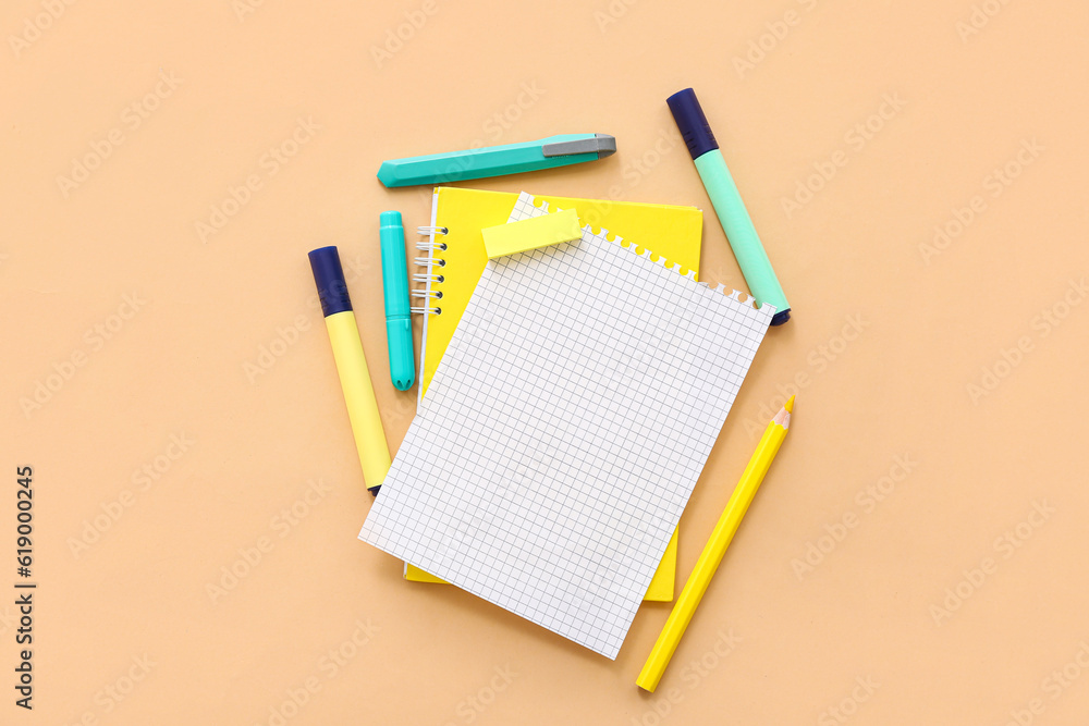 Blank notebook with different stationery on beige background Blank notebook with different stationery on beige background