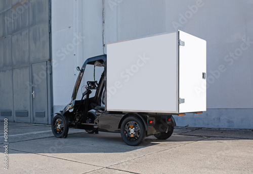 A modern electric delivery 4-wheel Quadracycle bike with a blank white cargo box with copy space for advertising. photo