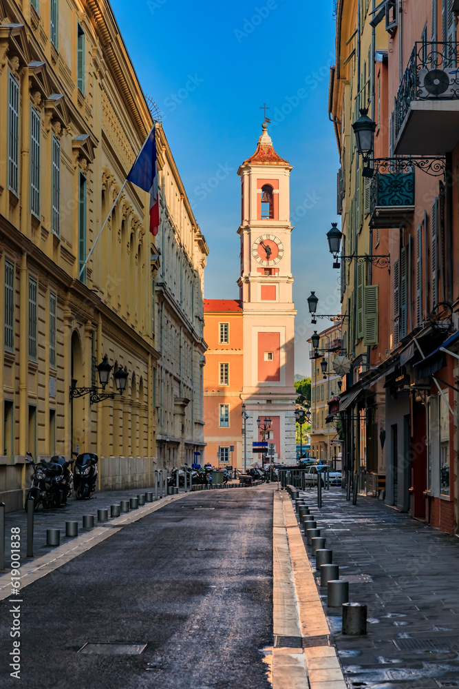Empty streets of the Old Town and the Caserne Rusca clock tower in Vieille Ville of Nice France at sunrise