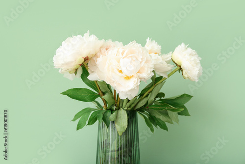 Vase of white peonies on green background © Pixel-Shot