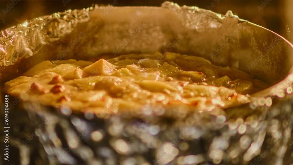 Apple pie in a baking dish cooking in the oven, timelapse Apple pie in a baking dish cooking in the oven, timelapse
