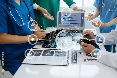 Medical technology network team meeting concept. Doctor hand working with smart phone modern digital tablet and laptop computer with graphics chart interface, with virtual icon diagram