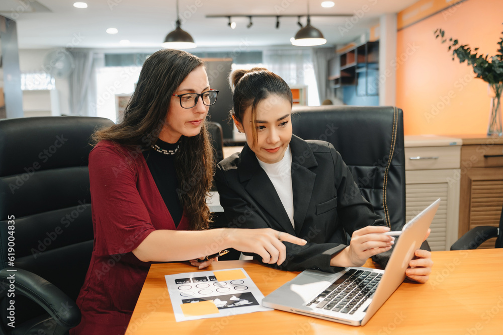 Kind leader executive manager share and discuss business solutions plan ideas on tablet with Asian female marketing manager in office.. Kind leader executive manager share and discuss business solutions plan ideas on tablet with Asian female marketing manager in office..