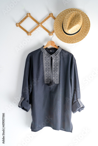 Ukrainian clothes embroidered man shirt. Blue gray and black threads background. Vyshyvanka is a symbol of Ukraine. Embroidery cross stitching. National Ukrainian stitch. Traditional clothing symbol.