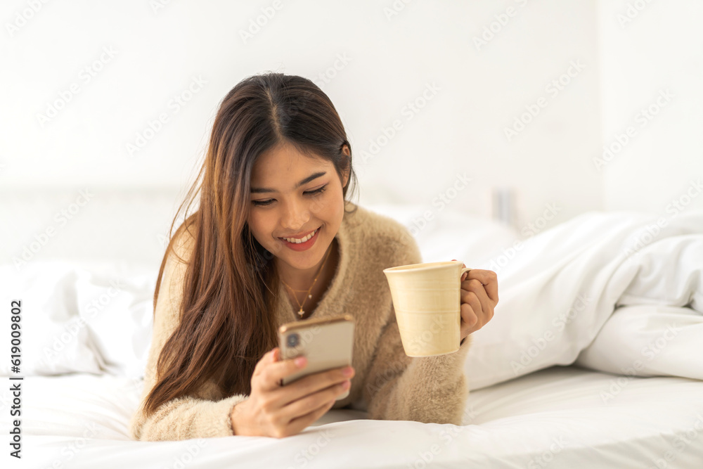Portrait of smiling happy asian woman relax using digital smartphone.Young asian girl working or study,chatting social network and playing game online or social media,shopping online at home Portrait of smiling happy asian woman relax using digital smartphone.Young asian girl working or study,chatting social network and playing game online or social media,shopping online at home
