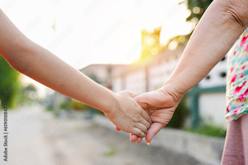parent holds the hand of a small child parent holds the hand of a small child