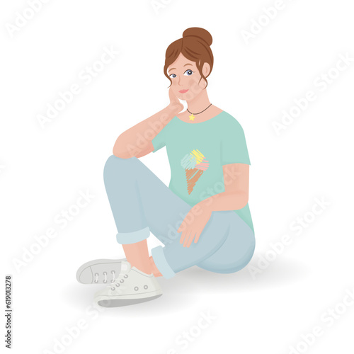 A fair-haired girl sits on the floor with one leg bent in jeans and a blue T-shirt with ice cream