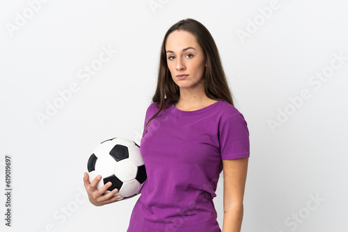 Young hispanic woman over isolated white background with soccer ball © luismolinero