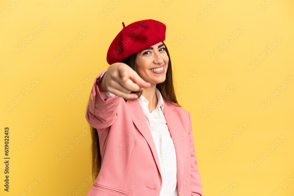 Young caucasian woman isolated on yellow background pointing front with happy expression Young caucasian woman isolated on yellow background pointing front with happy expression