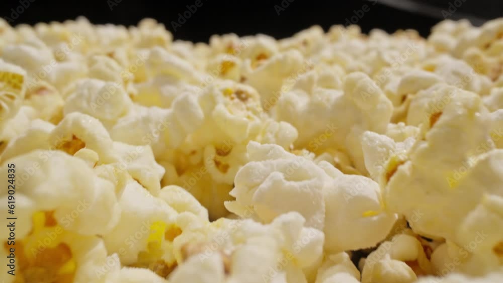 Camera moving in of delicious pop corn. Sweet popcorn. Close-up of fresh hot popcorn. Macro slide dolly shot. Laowa or astrhori probe lens. 4K, UHD Camera moving in of delicious pop corn. Sweet popcorn. Close-up of fresh hot popcorn. Macro slide dolly shot. Laowa or astrhori probe lens. 4K, UHD