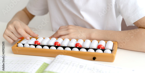 The boy is engaged in abacus  mental arithmetic for children