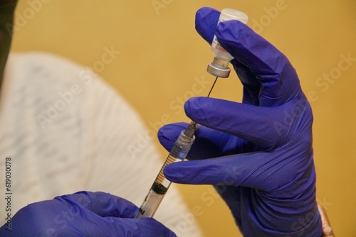 Doctor injecting with hypodermic needle