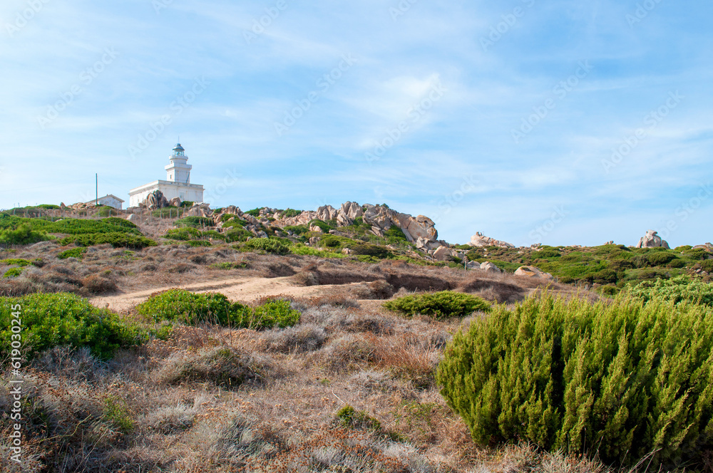 Rocky sea coast with a lighthouse in the Capo D'Orso area on the island of Sardinia, Italy