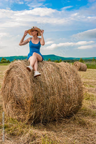 person sitting on bale