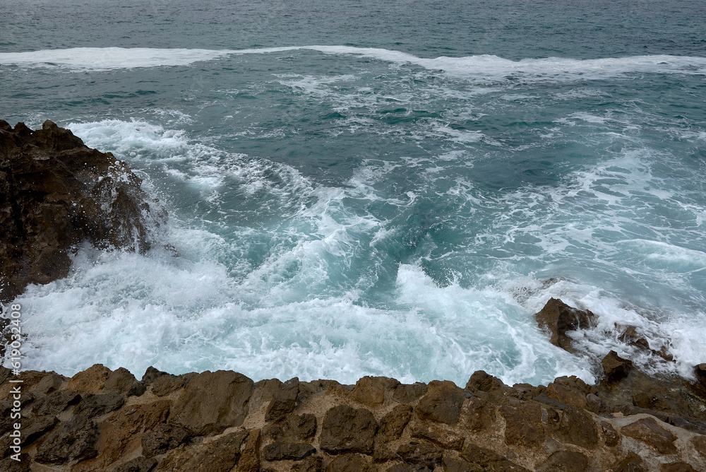 Waves breaking on the shore on a pebble road Waves breaking on the shore on a pebble road