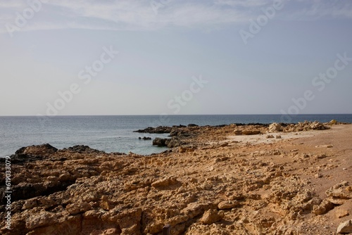 Scenic view of a tranquil beach against the sea on a sunny day