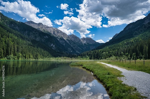 Landscape view of the clear water surrounded by high mountains. Jagersee river in Kleinarl. Austria photo