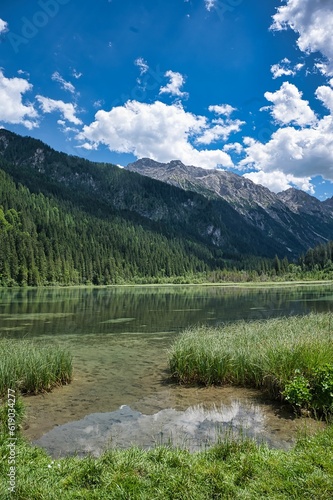 Landscape view of the clear water surrounded by high mountains. Jagersee river in Kleinarl. Austria