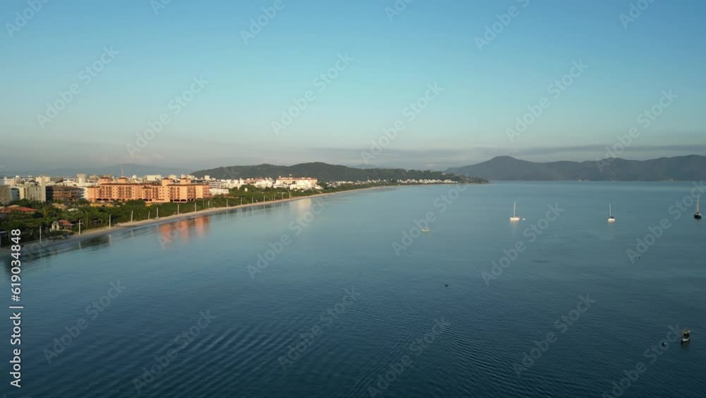 A side pan of the beach and a coastal line flyover in Juree Florianopolis, Brazil A side pan of the beach and a coastal line flyover in Juree Florianopolis, Brazil