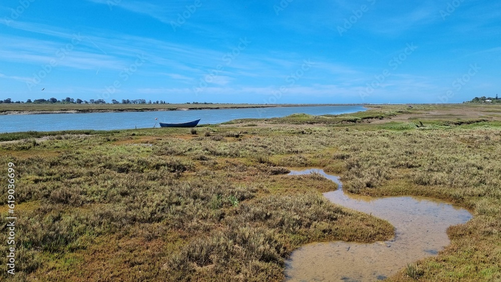 Scenic view of a boat near a lake in Ria Formosa nature reserve in Portugal Scenic view of a boat near a lake in Ria Formosa nature reserve in Portugal
