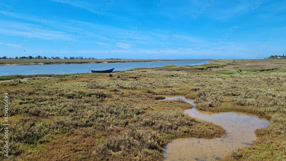 Scenic view of a boat near a lake in Ria Formosa nature reserve in Portugal