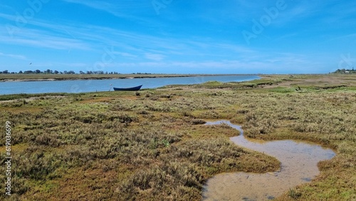 Scenic view of a boat near a lake in Ria Formosa nature reserve in Portugal