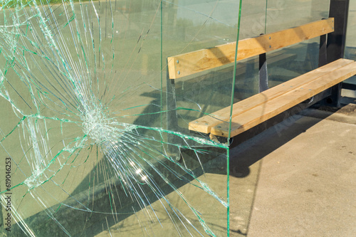 The broken glass wall of the bus stop complex