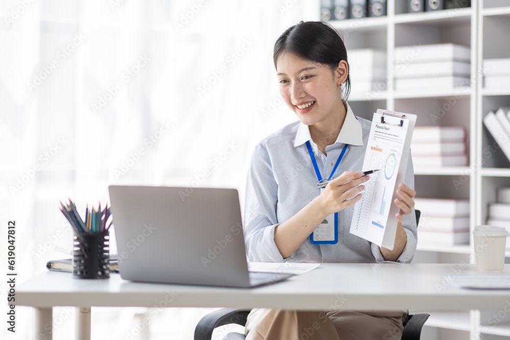 Business asian woman working at office with documents on his desk, doing planning analyzing the financial report, business plan investment, finance analysis concept Business asian woman working at office with documents on his desk, doing planning analyzing the financial report, business plan investment, finance analysis concept
