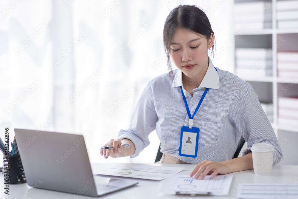 Business asian woman working at office with documents on his desk, doing planning analyzing the financial report, business plan investment, finance analysis concept Business asian woman working at office with documents on his desk, doing planning analyzing the financial report, business plan investment, finance analysis concept