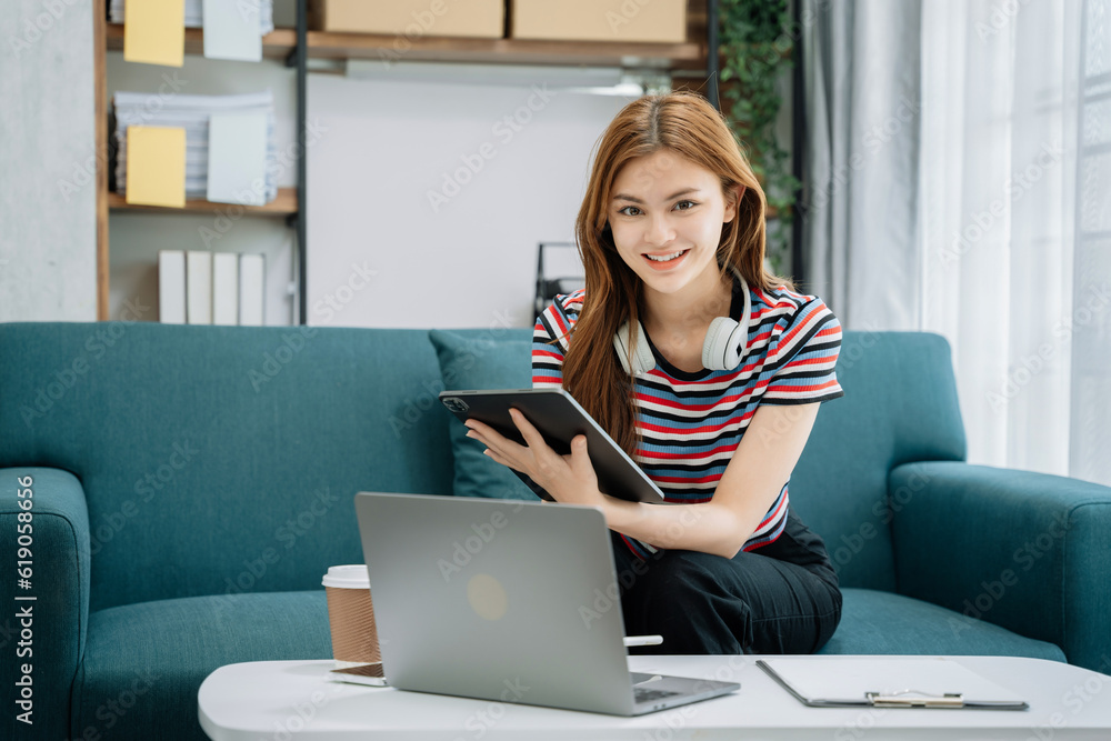 Female asian sitting on sofa, looking to camera. Female asian sitting on sofa, looking to camera.