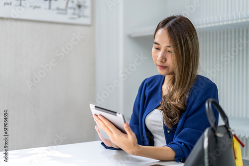 Portrait of smiling happy beautiful woman relax use digital network tablet.Young girl looking at screen typing message and playing game online or social media at cafe,online banking,payment